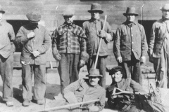 Coniston men at Ore Bins, Mond Nickel Company, Front sitting: John Storozuk, Nick Yrcha. Back standing: Charlie Mislinski, ?; Elie Rainville, John Solski, Philip Storozuk, & Frank Kilimnik. Photo City of Greater Sudbury Heritage Museums Collection